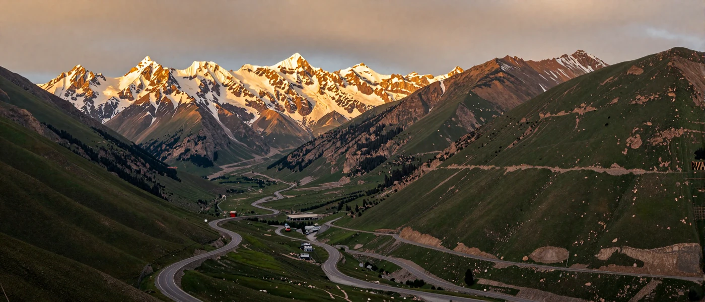 Pamir Highway winding through majestic Tajikistan mountains at golden hour representing the beauty of Tajik culture and heritage